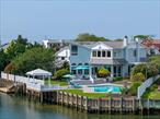 Nestled in a prime corner of Atlantic Beach Estates, this refined waterfront residence blends sleek coastal design with effortless indoor-outdoor living. Expansive walls of glass showcase sweeping bay views from the moment you enter, setting a striking tone throughout the home.The main level offers a seamless flow ideal for both entertaining and everyday living. A custom kitchen with designer cabinetry and premium appliances opens to a banquet-sized dining area and multiple lounge spaces, all designed to capture the natural light and water views.With six spacious bedrooms and six full bathrooms, the home provides flexibility for guests, work-from-home setups, or extended family. The private primary suite is a true retreat, featuring resort-style finishes and panoramic bay vistas from every angle. Additional bonus rooms across the home offer added versatility.Outside, enjoy a heated in-ground pool, a newly updated bulkhead, and a private floating dockâ€”perfect for boating, jet skiing, or simply relaxing by the water.Located just moments from the beaches, shops, dining, and energy of the Barrier Island, with easy access to the Five Towns, JFK Airport, NYC, and the LIRR