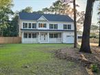 This beautifully built 2025 high ranch sits on 1/2 acre lot and offers 5 bedrooms, 4 full baths, and a spacious, flexible layout designed for modern living.Enjoy a large eat-in kitchen with quartz countertops, hardwood flooring, and central air conditioning. The home features two living rooms, a family room, and a versatile den that can also serve as a formal dining room. One bedroom includes its own private entrance, making it ideal for a home office or guest suite.The full basement features 9-foot ceilings, full egress windows, and a wide outside entranceâ€”perfect for extended living, a recreation space, or future customization. Both kitchen and all bathrooms feature sleek quartz countertops for a high-end finish.Located just minutes from Nichols Road for an easy commute and close to local shopping and dining. Exterior highlights include a 1-car attached garage, a 2-car detached garage, and parking for 10+ vehicles.A rare opportunity to own a brand-new, move-in-ready home with generous space, modern finishes, and a highly convenient location.