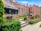 Set against the serene backdrop of Pelham Country Club, this beautifully renovated one-bedroom residence blends classic pre-war architecture with modern luxury. Enjoy sweeping golf course views from every window in this light-filled, Tudor-style condoâ€”an elegant retreat just minutes from shops, dining, parks, and the Pelham Metro-North station. Inside, a sun-drenched living room features a wood-burning fireplace, high ceilings, and rich hardwood floors. The kitchen has been thoughtfully updated with sleek cabinetry, premium appliances, and timeless finishes. The spacious primary bedroom includes custom-built closets and an additional flexible spaceâ€”perfect for a nursery, private office, or walk-in dressing room. Additional amenities include abundant closet space, a shared laundry located on the lower level and one assigned parking spot. This highly sought-after residence offers a rare combination of charm, convenience, and country club viewsâ€”all just one mile from Manhattan-bound trains.