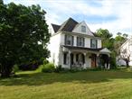 Welcome to this cherished family home with over 4 generations of love and memories. Enjoy time on the Covered Front Porch to sip afternoon tea and take in a beautiful breeze. Enter a spacious entry foyer, the living room is bright from sun light to the left and a dining room for the largest of gatherings! The kitchen has great space for meal prep with a mud room and 4 season room just off the back. Upstairs enjoy original wide plank hardwood floors, large rooms and a huge bathroom! There is a walkup attic with wide plank flooring as well that is perfect for storage. The basement area is home to the mechanicals and additional storage. Walking distance to the Village of Bloomingburg. Close to the highway, bus stop, park, shopping and more. Almost 2 acres of beautiful yard to enjoy with friends and your pets! Call today.