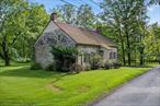 Prime location c.1771 Stone (Dutch Colonial) farmhouse in the historic hamlet of Kripplebush. Perfect for those who love history and this timeless style of stone house with thick walls and loads of history. The current layout on the main floor is very traditional, with two original fireplaces at opposite ends of the floor, at the two gable ends (somewhat north and south) highlighting a parlor on each side of a very large central entry hall with a front and rear door also opposite each other. The parlor to the N has a kitchen area and could be very nicely reconfigured to a marvelous eat-in dining room/kitchen. The S side parlor would make a very gracious living room. The floors are antique, old growth pine - very wide parts. There are stunning exposed ceiling beams supporting the upper level of the house. Up a historically accurate, enclosed staircase, you find what would be a wonderful space for 3 bedrooms and 2 full bathrooms, if the walls are re-configured to modern standards and perhaps some shed dormers are added for more windows. The space is currently somewhat primitive and comprises two bedrooms, a half bathroom and storage areas. The original floor boards are fully exposed and magnificent in their patina and their width. The rear door accesses a roomy screened porch overlooking the views to the S, and the &rsquo;&rsquo;Gunks&rsquo;&rsquo; and the Mohonk Tower seasonally without additional tree thinning. There is a hatch access attic above the upper level. Below the main level is a full basement with full access to the rear yard. Though not really suited for living space, it provides easy access below the main floor for upgrading of the infrastructure of the house. The location makes for easy access to the assets and venues of High Falls and Rosendale - the likes of INNESS, Mohonk, Minnewaska Park, Ashokan Rail Trail, Rosendale Trestle, and nearby Kingston. To allow viewing by out of area prospective buyers, the seller will review all offers 7/16 after 5pm. Buyer agents should inform Harris of any offers being submitted.