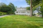 Welcome to this lovingly maintained 4 Bedroom, 2 Bath Colonial nestled on a beautifully landscaped .75-acre lot. Framed by stone pillars and a stone wall, the circular driveway adds curb appeal and a gracious welcome. Inside, this 1, 908 sq ft home showcases hardwood floors, 9-foot ceilings on the main level, crown moldings, and large windows that bathe each room in natural light. The main level features a walk-through kitchen, featuring stainless steel appliances, a bay window, and pantry nook. Enjoy gatherings in the large formal dining room or relax in the inviting living room with a fieldstone fireplace and French doors. A family/TV room offers additional space for downtime and is connected to a separate, large office, with a vaulted ceiling, skylight, built-in cabinetry, desks, and bookcases for a quiet work from home area. The versatile fourth bedroom or den, complete with a vaulted ceiling, built-in shelving, and a full bathâ€”ideal for guests, a home gym, or multigenerational living. Upstairs, youâ€™ll find a spacious primary bedroom and two additional bedrooms that share a well-appointed full bath. Additional highlights include an unfinished walk-out basement with laundry, storage, and utilities; a private patio perfect for outdoor enjoyment; and a one-car garage. Close proximity to Metro North, bike path, and within an array of dining and shopping options, this home offers the perfect blend of timeless elegance and modern easeâ€”ready to welcome you home!