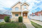 Stunning 2008 custom-built solid brick two-family home, nestled on a quiet, tree-lined street in the heart of Flushing, Queens. 40X100 Lot size. This well-constructed and meticulously maintained property offers a flexible layout perfect for extended families and great investment opportunity!First and Second floors feature two spacious bedrooms, a full bath, bright living and dining rooms, and eat-in kitchens with granite countertops. The second floor adds a charming front & rear balcony and a bonus home office, great for remote work or study. Gleaming hardwood floors run throughout, with ample closet space and an abundance of windows that fill each room with natural light. The full basement, with separate entrances, offers a large recreation area and versatile space. A private driveway fits up to four cars, plus a detached garage. Enjoy a serene, park-like backyardâ€”perfect for relaxation and entertaining.Prime location near Kissena Corridor Park, H Mart, shops, and restaurants. School District Queens 26 Ps162 /Jhs 216. Convenient access to multiple bus lines (Q26/Q27/Q12/Q13/Q31), the LIRR, and major highways makes commuting a breeze. Donâ€™t miss this Flushing gem, make it yours today!