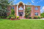 NORTH HILLS. Welcome to this incredibly young Brick Center Hall Colonial located privately within cul-de-sac location of 5 equally grand estates in the Village of North Hills. Instantly greeted with tall curb appeal and mature & beautiful landscaping, this home is a treat! Come through wrought iron doors to your grand entrance foyer, featuring half spiral staircase, tons of natural light (East exposure), radiant heated tiled floors, and impeccable detailing. Bright and open spaces, while holding true to the traditional rooms, formal living room, formal dining room with additional sunroom access, family room with fireplace and large balcony overlooking from 2nd floor landing, grand cooks kitchen with breakfast nook and desk space - with access out to the back patio, 1st floor bedroom and full bathroom, with 4 large bedrooms on the 2nd floor, large primary suite with walk in closet (2 of them, or 1 can be utilized as an office) and primary bath, attic space, full basement with outside access, and much more! Features include: radiant heated floors and hardwood floors where seen throughout, wainscoting and intricate detailing, recessed lighted ceilings, high ceilings, custom closets and cabinetry, stainless steel appliances, butler pantry with additional sink, tons of storage!! 4 car garage - 2 attached and 2 detached. Will not last!!!