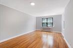 Sun-filled one-bedroom condo for sale in East Elmhurst, New Yorkâ€”just minutes from LaGuardia Airport. Situated on the fourth floor of a low-rise walk-up building, this bright corner unit features windows on three sides, inviting abundant natural light throughout the day.As you enter, a welcoming foyer with a large closet offers ample storage. The spacious living room overlooks leafy trees and the peaceful condo courtyard. The kitchen is well-appointed with generous counter space and a window with courtyard views. A washer is also conveniently located in the unit.The oversized bedroom features dual exposures and a large closet, while the windowed bathroom sits just next door. Additional highlights include hardwood floors throughout, updated windows with window treatments, and freshly painted walls. This move-in ready home combines charm, light, and convenience in a prime Queens location.