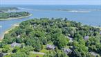 Nestled on a private one+ acre lot and framed by mature landscaping and water views 2 White Pine Lane offers an incomparable lifestyle opportunity in a peaceful setting surrounded by natural beauty. The picturesque waterside community of Poquott offers residents beautiful stretches of private beaches and the prime location of this home ( steps away from Van Brunt Manor Beach) makes it the perfect location to enjoy your own private beachfront retreat and numerous waterfront recreational activities. This well-built Farm Ranch has great curb appeal that is highlighted by colorful plantings, a covered front porch, side entry Carraige style garage doors, white picket fence and cultured stone accents. A spacious & gracious entrance foyer welcomes you to the sun filled interior and the unique floor plan offers a great combination of formal and open concept living spaces. There is also a main level primary suite with a brand new & beautifully renovated spa like bathroom, a large updated eat in kitchen overlooking backyard where you can enjoy relaxing by the pool or entertaining family and friends on the lovely decking overlooking park like grounds.Additional amenities include oak flooring, recessed lighting family room with fireplace, updated bathrooms, second story loft area overlooking main living space and more! Additional Village amenities include deep water mooring and beach rights, private security, community dock, tennis, parks, playgrounds and year-round community events. Enjoy sunny days at the beach and magical sunsets at the dock, a priceless lifestyle opportunity awaits you!