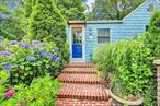 Good Beachy-Garden Vibes in this adorable bungalow home with SUPER LOW, LOW TAXES!. Enter through the front yard garden gate to a private garden front yard, a brick walkway and steps to the front door entry, front entry hall features shelving that can be converted to coat closet and opens to living room with wainscoting on walls, LifeProof vinyl flooring, full bath, sliding glass door onto deck and backyard. 2 bedrooms- Anderson double pane windows throughout. Galley kitchen with updated cabinetry, hardwood flooring, recessed lights, dining area overlooking the private front yard perennial garden. Updated full bath. 7 yr young roof, 2 yr young oil burner, partial unfinished basement with washer/dryer, above ground oil tank, 3 sheds in back yard for storage.