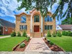 This beautifully reimagined custom brick home with soaring columns offers luxurious living with modern updates from the ground up, situated on a 60x100 lot. Boasting 3, 105 sq ft of refined space, this residence features five spacious bedrooms and three and a half bathrooms, including a first-floor bedroom perfect for guests or generational living.Step into the formal living room adorned with oversized Anderson windows, two elegant chandeliers, and a grand circular staircase. Designed with ample natural light, the space is surrounded by large windows that let sunlight pour in throughout the day. The open layout and bright ambiance make this living room an ideal setting for relaxing, entertaining, or spending quality time with loved ones. Custom-made doors throughout the home add unique charm and craftsmanship.Step into a beautifully lit family room that radiates warmth and comfort. Elegant arched walkways lead in and out of the room, adding architectural character and a soft flow between living spaces. The chef&rsquo;s kitchen is a dream, featuring custom cabinetry, granite countertops, stainless steel appliances, and a sunny eat-in area. The formal dining room is ideal for entertaining with French doors opens to a rear deck with awning, leading to a private backyard.Upstairs, find four generously sized bedrooms. The primary suite offers a spa-like retreat with a soaking tub, walk-in closets, and ample natural light.The fully finished tiled basement adds valuable space with a rec room, surround sound, half bath, laundry room, utility room, and private access to the backyard.Additional features include hardwood floors and recessed lighting throughout, two-zone central heating system, an elegant design with modern conveniences, an ADT security system, and close proximity to schools, parks, shopping, transportation, and houses of worship.This is more than a house - it&rsquo;s a place to call home.