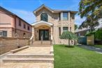 Welcome to this beautiful custom home with impressive cathedral ceilings that set the tone for elegance. As entering the foyer, enjoy spacious living areas: including a large living room, formal dining room, cozy family room, a beautifully designed kitchen and powder room. As going up to a second Floor you will be impressed to see the three generous sized bedrooms, featuring custom closets and two full baths. A laundry chute adds practical convenience. Enjoy the lower level for entertaining and relaxation, with a large playroom, office, laundry room, powder room and additional storage space. A sliding door to backyard leads to a cozy porche with pergola (equipped with lights and heating), backyard, private driveway, and detached garage. This exquisite home combines classic charm with many amenities, offering both style and comfort.