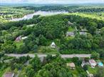 Endless Possibilities in Cornwall Central School District-6.9 acres, two parcels, 4 Bedroom 2 Full Bath Home! Bring your vision to this charming 1900â€™s farmhouse to its full potential. Two wells (1 dug and 1 drilled), septic, and all utilities on. New Regal Furnace, New Gutters, hardwood floors, Old Style charm. Almost 7 acres spread across two parcels, offering incredible opportunities for renovation, expansion or even another house. Ample space for gardens, privacy of rural living yet minutes to highways, shops, train station and schools. Beaver Dam Lake Rights. Go enjoy private beach, kayak, and fish. This home was a families home for many generations. Parcels this size and location in Salisbury Mills are hard to come by. Donâ€™t miss this unique opportunity to invest in land, location and long-term value. Front porch overlooking the mountains, cozy kitchen, spacious living room, formal dining room, 2 full baths, 4 bedrooms, walk up attic. This home is being sold AS-IS. Conventional, 203K or Cash. Two lots included: Tax ID:1-1-83 with Colonial Home on 6.40 acres and Tax ID: 1-1-82 adjacent parcel above house lot 0.33 acres. Could build another house on second parcel or keep it as is for additional land and privacy in this picturesque setting. (Sellers in process of clearing out house. Please excuse the clutter) More photos coming soon.