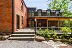 Tucked into the heart of Croton-on-Hudson, this unique residence is a masterful blend of 19th-century heritage and thoughtful modern architecture. Originally constructed in 1859 by laborers from the nearby Cocks and Barlow Brickyards this brick home stands as a testament to the areaâ€™s history.A striking double height glass corridor now links the original structure to a contemporary addition, where architectural details and finishes echo the history of the main house, creating harmony across centuries. A solar-paneled pergola shades the front patio and provides a surplus of electricity.Inside, the chefâ€™s kitchen features countertops crafted from Black Walnut trees felled on the property. The custom island cabinetry was built by the current owner, as were the exquisite architectural details that continue throughout the home. Salvaged antique doors, sourced from Hudson Valley architectural yards, have been restored with vintage porcelain knobs and cast iron locks. Wide-plank pine flooring laid with square nails match the original flooringâ€”an homage to the craftsmanship of another era. The bathrooms have been artfully decorated with antique vanities and marble-tiled floors.The lower level provides a partially finished bonus space ideal for a gym, office or playroom. The two structures combined offer one exquisite home with four bedrooms and two-and-a-half baths, including a first-floor bedroom with ensuite with its own separate entrance. Located just a short walk from the vibrant heart of Crotonâ€™s village center, enjoy proximity to schools and beloved local favorites including The Black Cow Coffee, The Blue Pig, and the Croton Tap Smith. Express trains run to Grand Central Station for a 60 minute commute. This home is a rare blend of timeless architecture and purposeful design located on a coveted village street. Timeless architecture, sustainable design, an easy city commute, walkable downtown access and generous outdoor space. This is the rare home that checks every box.