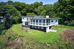 Amazing Riverfront home on the Hudson River. Sunroom has wall to wall windows facing directly on the Hudson River. Master bedroom has breathtaking river views and a balcony to sit and enjoy your private Hudson river views. Has 4 full bedrooms but also 2 large extra rooms on first floor with a full bath perfect for an in law setup or offices. First floor has sliding glass doors leading out to your private backyard and full river views. Almost all rooms capture the stunning river views. Freshly painted inside and out. Newer floors thru out with a new woodburning stove in the living room. Large detached 2 car garage. Brand new septic system installed less than 2 years ago and Town water. Truly a one of a kind home with some of the best river views you can imagine.