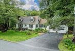 This quintessential Cape Cod with spring-fed pond located on a magnificent farm filled country road between Millbrook and Stanfordville awaits you. Entering, you will find the living room with wood burning fireplace, and a library/den (currently set up as a bedroom). There is an oversized open kitchen with a bay window dining area and abundant storage. Off the kitchen is a heated, bright sunroom with glass doors and walls of windows overlooking the backyard and pond. There is a full bath on this level in addition to an entertainment room/den leading to the two-car garage. Hardwood oak floors and six-over six double pane windows are throughout. On the upper level you will find the primary ensuite bedroom, as well as other rooms, one including access to a playroom and through to a storage area above the garage. House comes with portable generator and also invisible dog fencing. This nature loverâ€™s location is close to preserves, hiking, biking, swimming and skiing. Also nearby are the towns of Millbrook, Stanfordville, Pine Plains, Rhinebeck and more. All include dining and shopping. Farmers Markets and Wineries are nearby. This is just two hours from New York up the Taconic State Parkway or via Metro North or Amtrak. Welcome to the Hudson Valley!