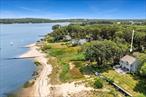 Live your best life in this spectacular 5 bedroom bayfront home. Breathtaking panoramic water views from Shelter Island throughout Greenport Harbor to Pipes Cove, you will be able to sit on your private beach and watch all the activity of the Peconic Bay. This beachfront home offers a first floor bedroom en-suite, enclosed sunporch, open floor plan across the living room with wood burning fireplace, dining area into the kitchen. The second floor offers 4 large bedrooms and a full bathroom. There are hardwood floors, central air conditioning, laundry on both floors, partial full height basement, and a beautiful waterside composite deck to enjoy the most amazing water view!
