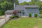 Nestled in the serene neighborhood of Hyde Park, this beautifully updated split-level contemporary home blends warmth, style, and function. The welcoming entryway leads to a light-filled living room, where oversized windows and a stone fireplace framed by refinished wood built-ins create an inviting space.The impeccably renovated kitchen is the perfect place to unwind with a glass of wine while enjoying the evening sun. It opens seamlessly to the dining area and living room, offering easy flow for everyday living and entertaining. The door from the dining room leads to a spacious patioâ€”ideal for outdoor gatherings with friends.Up a short flight of stairs, the primary bedroom offers two generous closets and a nod to mid-century design, with high-set windows that provide natural light while maintaining privacy. One more bedroom is down the hall with the first bathroom, and up a few more steps to the third and fourth bedrooms and additional bathroom.Downstairs, a large finished basement offers versatile spaceâ€”perfect as a playroom, art studio, or media roomâ€”with sliding doors that open to the backyard. There is half bath and laundry room adjoining this space. Hidden behind the home is a rare gem: a detached 4-car garage with an expansive workshop and a large loft space that can be used as an art studio, or office.