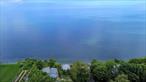 NESTLED ON LONG ISLANDS NORTH SHORE BLUFF- THIS LITTLE SLICE OF HEAVEN OFFERS THE TRANQUIL SOUND OF THE WATER WASHING ASHORE, UNOBSTRUCTED BREATHTAKING WATER-VIEWS AND BEACH VIEWS, This home was renovated in 2014 and additional Renovations done including Windows, & Sliders Added in 2023 to Accentuate THE WATERVIEWS. Updated Eat In kitchen W/White Cabinetry, Granite Counters, Subway Tile Back Splash, Updated Bathroom accented with Shiplap, Engineered Wide plank White Oak Floors, Vaulted Rustic Beamed Ceilings for the authentic cottage feel, Mini Split for Heat & air, Double SLIDERS to entertainers Deck Also w/Wide Plank Boards, Stackable washer/Dryer, New Stove, New White Storage Cabinetry, 2 Sofas,  & Captains Bed with Storage, Exterior Painted 2021 in a Soothing Blue Tone, Interior Freshly Painted 2024, Additional Tiered Deck Off Side for Sunbathing, Rose Bushes & Perennial Plantings offer charm & make it feel like home. Furnished & Ready to Use. Only 1 Hour & 15 Minutes to NYC. Jitney Bus is only 8 Minute Drive from Community. Community is Seasonal open April 15-October 15. Land is Leased at approximately $12, 400 annually. Short term rentals Prohibited. Was two separate bedrooms but currently walls down and set up as Open Concept. Could be put back up., Additional information: Appearance:Mint