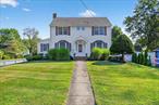Welcome to a 4 BEDROOM COLONIAL WITH A DETACHED TWO-CAR GARAGE nestled in the heart of Poughkeepsie! This amazing well maintained corner lot home has its own beauty and charms. From the moment you step inside, youâ€™ll appreciate the layout of the first floor with its beautiful hardwood floors. The welcoming foyer provides access to a bright spacious family room with a gas fireplace leading to another room perfect for your office, den or the 5th guest bedroom. Across the hall, you will see a great size formal living room with plenty of natural lights coming through the windows (this room can possibly be used as a formal dining room). Then you will enter to the the updated gourmet kitchen with a bright and spacious size additional room ideal for your dining table. The kitchen features a marble station, granite countertops, custom cherry wood cabinets and stainless-steel appliances. The laundry are and a cozy powder room complete the first floor. Upstairs, youâ€™ll find four generously sized bedrooms, including a large primary bedroom with its own master bathroom and semi walk in closet and a hallway full bathroom. The walk-up, full unfinished attic offers endless possibilities for expansion or additional storage, while the large basement provides even more space for storage or a potential workshop. Last but not least, the side entrance three season closed porch with windows has a hot tub that requires natural gas hook-up Located in an ideal location, youâ€™ll be just minutes from shopping, medical facilities, schools, restaurants, major highways and NYC Metro North train station. This incredible home wonâ€™t last. Please call now for your showing appointment.
