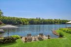 LAKEFRONT DREAM HOME! Resting in the serene countryside of picturesque Putnam Valleyâ€”just one hour north of NYCâ€”youâ€™ll discover your own private slice of paradise. This is not just a home, itâ€™s a full-time vacation. Every time you return, it feels like youâ€™ve escaped to a resort, where peace, beauty, and nature greet you at the door. Tucked along the pristine shores of Roaring Brook Lake, this property offers a rare and majestic connection to the waterâ€”literally right outside your back door. Spend quiet mornings swaying in the hammock, the breeze in your hair and the lake sparkling before you. Sip coffee or cocktails from the deck or sunroom, where expansive windows bring the outdoors in and offer uninterrupted water views from nearly every angle. Inside, the main living space is pure magic. A wide-open layout blends the cozy living roomâ€”complete with wood-burning fireplaceâ€”with a generous dining area and an absolutely stunning eat-in kitchen. Outfitted with granite countertops, stainless steel appliances, a wine fridge, and plenty of room to cook and gather, the kitchen was made for entertaining with the lake shimmering in the background. A first-floor guest bedroom offers ultimate flexibilityâ€”perfect for visitors, a home office, or denâ€”along with a full bathroom nearby. Head upstairs and prepare to fall in love all over again. The primary suite is a peaceful retreat with breathtaking lake views youâ€™ll wake up to every morning, plus a luxurious ensuite bath featuring a soaking tub and separate shower. A second spacious bedroom and a third full bathroom complete the upper level. Need more? Thereâ€™s a large basement with finishing potential, attic storage, and a fabulous oversized two-car garage. If youâ€™ve been dreaming of the ultimate waterfront lifestyle without leaving behind space, comfort, or luxuryâ€”this is it. This is everything you&rsquo;ve been hoping for... and so much more. Come see the lake life you&rsquo;ve always imaginedâ€”right here, right now.