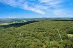 Down a winding country road, across the street from 350 acres of hiking trails and just 10 minutes from the heart of Pawling, this 5.36-acre parcel offers a rare blend of readiness and wildness. This is the kind of place where ideas can take shape beneath a canopy of oaks and mountain laurel. The elevated, partially cleared build site holds promise for views, with a roughed-in driveway already in place. Electric is available at the road, and a septic system has been installed. With an approved site plan in hand, you can skip the red tape and begin envisioning your dream projectâ€”be it a modern cabin, timber-frame retreat, or a passive home designed in harmony with the land. Pawling, just minutes away, hums with small-town charm, while a quick trip down the road takes you across the Connecticut border into Sherman, where access to Candlewood Lake awaits. Golf courses, Thunder Ridge ski area, and serene catch-and-release fishing spots all lie within easy reach. Numerous day and boarding schools, plus legendary summer camps, are also within striking distance. 51 Kirby Hill Road is a rare find in desirable Quaker Hill: a parcel that feels worlds away, yet is just 1 hour and 20 minutes from New York City. Where the landscape sets the toneâ€”and your ideas can take root.