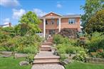 Stately 7-Bedroom, 7-Bath Brick Estate with Water Views in Prime Woodsburgh Location. Rare opportunity to own a sprawling 7-bedroom, 7-bathroom residence on a quiet, tree-lined street in the heart of Woodsburgh. This elegant all-brick home offers timeless design, spacious interiors, and stunning views of the surrounding natural beauty. The sun-filled main level features a large gourmet eat-in kitchen with oversized breakfast bar, formal dining room, open living room, and a spacious den with fireplaceâ€”all with scenic views. Two first-floor bedrooms provide flexibility for guests or multigenerational living. Upstairs includes five generously sized bedrooms, including a luxurious primary suite with walk-in closets, spa-like ensuite bath, and water views. Additional highlights include hardwood floors throughout, abundant closet space, and a large finished basement with room for recreation or storage. Set on an expansive, beautifully landscaped lot with room for a pool. The grand circular driveway offers ample parking for multiple vehicles. Located just minutes from beaches, golf, LIRR, and Five Towns shopping and dining. This exceptional property blends privacy, space, and prestigeâ€”donâ€™t miss this rare offering.