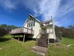 Unique two bedroom contemporary home on 23.72 acres in T/Bethel!  Incredible panoramic views. Great opportunity to renovate or build your dream house. Close to the Resorts World and Bethel Woods and Sullivan County lakes.  Sold as-is. Buyer to pay NYS and any local transfer taxes. Offers with financing must be accompanied by pre-qual letter; cash offers with proof of funds. **Please see agent remarks for access, showing instructions and offer presentation remarks.**