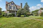 This expansive Center Hall Tudor home offers 5 bedrooms, 3.5 baths, and is filled with natural sunlight throughout. Inside, youâ€™ll find a banquet-size formal dining room, a spacious living room with a wood-burning fireplace, and a welcoming family room complete with a wet bar and full bathroom. The first floor also includes an eat-in kitchen, a bedroom, a half bath, and a convenient laundry room. Upstairs, the second floor features three generously sized bedrooms, a hall bathroom, and a luxurious primary en suite. A walk-up third floor provides ample storage space to meet your needs. The large basement offers additional space ideal for entertaining, whether it be a media room, playroom, or home gym. Additional highlights include a two-car detached garage, an alarm system, and in-ground sprinklers.This home offers more than meets the eye. Located close to top-rated schools, parks, shopping, and public transportation, this exceptional property is a rare find. Donâ€™t miss your chance to make this dream home yours!
