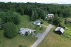 Set back privately on a dead-end road this multi-use property offers endless possibilities. With 35.86 acres of open and wooded land complete with pond and stream, and additional land available, there is so much potential for almost anything your heart desires. Multiple outbuildings and two residences enhance this great set-up for agri-business, farm, various home occupations or a laid-back country homestead. The quaint old farmhouse still has many original details from yesteryear and offers 4 bedrooms, 1.5 baths, cozy eat-in-kitchen, dining room, living room, flex room plus a bar and a woodstove. 2 BR mobile home, 980 SF, is nicely arranged on the property and is great for a rental or expanded family. The setting is simply gorgeous with rock outcroppings, open fields, magical woodland, spring fed pond (plus additional pond site) and Creamery Brook running through. Property used to be used for horses and farm animals but fencing needs to be replaced. There is an old barn as well as two large outbuildings, one with lifts, perfect for toys, big machines, auto mechanics, collectors, artists, woodworkers, etc. Previous use was auto repair and salvage yard with current licensing still in place and transferrable. Located in Bethel, NY in the Sullivan County Catskills, and near to many amazing amenities including Bethel Woods Center for the Arts (original 1969 Woodstock music festival site), area lakes, restaurants, breweries, casino, waterpark, hiking, skiing, the prestigious Monticello Motor Club and more!