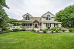 This Magnificent custom built home with wrap around porch is set over on over an acre of level property. Enter into a two story foyer with gleaming hardwood floors high ceilings and custom moldings. This beautiful colonial is full of light with its custom Andersen windows and large rooms throughout. The eat in kitchen has French Country style cabinets with center island, granite counters stainless appliances and a large eating area. The kitchen opens up into the family room with a wood burning fireplace and wall to wall windows. There is a first floor laundry room and powder room. The stunning stair case leads up to a balcony overlooking the first floor and the bedrooms. The primary bedroom is extremely spacious with a tray ceiling two walk in closets and ensuite bathroom. There are three additional oversized bedrooms. The yard is stunning with parklike property gorgeous green lawns and patio . This property was originally used for horses so has a fabulous barn with water and electric and large area perfect for a pool, sports court etc. This home has many updates inc the roof, heating system central air and has been impeccably maintained. This is truly and amazing home ready to make your own