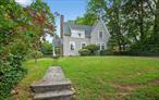 This beautifully preserved 1925 Colonial Revival home is tucked into the heart of the Douglaston Hill Historic District, where storybook charm meets timeless design. Designed by Aubrey B. Grantham and built by renowned local craftsman Samuel Lindbloom, the home exudes character and grace, from its wood-shingle exterior to its intersecting gables and original six-over-six sash windows.A thoughtfully proportioned layout includes a spacious, sun-filled living room with a wood-burning fireplace and a south-facing dining room that could easily be transformed into a first-floor bedroom with its own ensuite full bath â€” an ideal option for guests, one-level living, or future planning. The kitchen overlooks the green backyard, where mature plantings, a beautiful stone retaining wall, and a blue slate patio create a peaceful and private setting.Upstairs, youâ€™ll find two to three bedrooms and another full bath, all nestled beneath a charming shed-roof dormer that enhances both light and space. Outside, winding stone pathways, fieldstone accents, and cobblestone street edging highlight the care and character of the grounds.Lovingly maintained and full of original detail, this home offers a rare blend of privacy, charm, and neighborhood pride â€” all just blocks from the Douglaston LIRR station and the waterfront. A special offering in a truly special enclave.