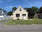 Move right in to this 4 bed 2 1/2 bath home in Mastic Beach. Only minutes to the water but far enough to be in Flood Zone X (No flood ins needed!!) Super low taxes at $4132.60 a year! The boiler and roof are 13 years young, new updated 100 AMP electric panel,  minimum 4 cesspools, new cement floor in garage and basement, large 1 1/2 car garage, SS stove, frig, W/D hookups in basement, oversized yard, long driveway on one side and large side yard on other. This home is close to shopping and transportation. CALLING ALL INVESTORS...Home is approved for Sec 8 $3500 a month, Cap rate 8.36%