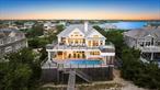 Introducing a Coastal Paradise! Nestled in the coveted Village of Westhampton Beach, this stunning oceanfront gem on Dune Road between the bridges awaits you! Set on approx. 100 feet of direct oceanfront, this over 4, 000 sq ft stunner offers luxury, privacy, and unbeatable views. The first floor features four spacious bedrooms, three full baths, an expansive family room, and seamless flow to the Brazilian mahogany deck, where a heated gunite pool, outdoor shower, and private beach walkway await. Upstairs, enjoy soaring ceilings, a chef&rsquo;s kitchen with granite countertops, an open dining area, and a bright living room with a fireplace - all leading to the oversized deck with panoramic Atlantic views. The primary suite is your sanctuary, complete with spa-style bath, a private balcony, large gunite hot tub (seats 12), and endless ocean views. There also is a finished lower level with a full bath, three finished rooms, and access to a two-car garage. Located between the bridges and just minutes from the shops and dining of Main Street, this is oceanfront living at its finest.