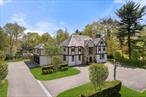 Discover the epitome of old meets new in this architectural marvel featuring a meticulously 2013 renovated Tudor manor house thoughtfully expanded with an exquisite contemporary addition. Situated on 1.36 professionally landscaped acres, this award-winning residence by Joeb Moore impresses with a sun-splashed indoor-outdoor open layout, five en suite bedrooms, and an enviable location in the coveted Grange section of Scarsdale&rsquo;s Greenacres. A gracious entry with a seating area opens to a welcoming formal living room wrapped in classic Tudor windows and a sleek wood-burning fireplace. Across the entry, the spacious dining room sets the stage for memorable gatherings. Culinary adventures await in the magazine-worthy gourmet kitchen, where sleek custom white oak cabinetry and swaths of Calacatta Gold marble join a fleet of Miele appliances, including a gas cooktop, wall oven, built-in microwave and integrated coffee system. Enjoy casual meals at the massive waterfall island or sun-kissed breakfast room, or relax in the adjacent family room flanked by a two-sided linear fireplace and mesmerizing, floor-to-ceiling outdoor views. A large study, music room, mudroom entry and powder room complete the beautifully planned main level, while the finished lower level boasts a recreation room, gym area, laundry room and second powder room. Ascend the floating stairs to explore the serene owner&rsquo;s suite, where the king-size bedroom features a custom bed enclosure integrated nightstand. Oversized windows open to the home&rsquo;s innovative sedum green roof that provides both verdant outlooks and superior water retention and drainage benefits. In the en suite primary bath, Kenya black marble ties together the wide floating double vanity, illuminated shelving and oversized shower. There&rsquo;s a well-appointed secondary suite on the second level, plus two more spacious and bright bedrooms joined by a Jack-and-Jill bathroom. Another bedroom with a full bathroom is found on the attic level. Outside, the expansive resort-like grounds make outdoor living irresistible with a large entertaining patio, a terraced pool and spa area, and a separate in-ground concrete spa with a cover for year-round usage. Sprawling lawns surrounded by towering trees and manicured hedges add exceptional privacy throughout the 1.36-acre property. A long driveway, motor/basketball court and three-car attached garage add generous off-street parking, and a whole-house generator provides peace of mind. Located in Greenacres&rsquo; sought-after Grange estate section, and zoned for top-rated schools, including the newly renovated Greenacres Elementary. Parkways and Metro-North trains provide easy access to New York City and beyond.