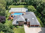 Welcome to this beautifully updated 4-bedroom, 4-bath contemporary home, offering approximately 3, 700 square feet of luxurious living space and set on 1.06 lush acres in an idyllic private setting. Ideally located just minutes from Westhampton&rsquo;s charming shops, restaurants, and pristine beaches, this stunning residence combines modern amenities with ultimate privacy and outdoor enjoyment.The open-concept living area features soaring high ceilings and expansive windows that flood the space with natural light. The living area flows effortlessly into the dining area, creating a perfect flow for both everyday living and entertaining. Sliding glass doors lead to the summer retreat of your dreamsâ€”an expansive outdoor deck and lounge area that seamlessly connects the indoor and outdoor living spaces. Whether you&rsquo;re hosting guests or enjoying a quiet moment, this open space invites you to fully experience the best of both worlds.The homeâ€™s thoughtful updates include a new roof (2018), new gutters (2018), and newly updated doors and windows (2023), all ensuring a modern aesthetic and energy efficiency. The primary suite serves as a tranquil retreat, featuring a spa-like bath with luxurious finishes and direct access to a private balcony overlooking the beautifully landscaped backyard. This serene outdoor space is ideal for enjoying your morning coffee or taking in the peaceful surroundings at sunset.The meticulously landscaped grounds offer an outdoor living experience like no other. Recent landscaping updates include 200 new trees planted in 2023, a newly installed deer fence (2022), and a freshly stoned driveway (2019). The backyard is an entertainer&rsquo;s paradise, featuring a heated pool with a new pool heater (2020), pool salt generator (2023), pool pump (2019), and a new pool liner (2025). A new outdoor kitchen (2021) sets the stage for al fresco dining, while a Har-Tru tennis court and multiple lounge areas offer plenty of space for relaxation and recreation.Other notable updates include:â€¢ New garage doors (2019)â€¢ New driveway gate (2023)â€¢ New blinds and shades (2023)â€¢ New sprinkler system (2020)â€¢ New sod (2020)â€¢ Two new AC units (2020/2021)â€¢ Two new boilers (2021)â€¢ New hot water heater (2021)â€¢ New oil tank (2022)â€¢ New washer & dryer (2023)â€¢ New dishwasher, stovetop, and oven (2018)Designed for both comfort and style, this home also boasts energy-efficient systems and smart upgrades throughout, such as the new fireplace mantle and freshly painted exterior (2018).With no detail overlooked, this exceptional home offers a rare opportunity to enjoy private luxury just moments from the vibrant center of Westhampton Village, This property is the ultimate in Hamptonâ€™s Living.