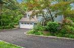 Beautifully updated 4-bedroom, 2.5-bath Dutch Colonial in the sought-after Kisco Park neighborhood, located within the Chappaqua School District. Set on 0.48 acres of park-like property with mature trees, stone walls, patios, and a quiet cul-de-sac setting. The sun-filled interior features refinished oak hardwood floors, crown moldings, and an open, functional layout. The high-end eat-in kitchen includes Thermador double ovens, a 42 built-in fridge, new 5-burner cooktop, dishwasher, microwave, and a bright breakfast area. The main level also offers a formal dining room, large living room with fireplace, spacious family room with fireplace and French doors to a stone patio, powder room, and two mudrooms. The primary suite boasts two walk-in closets, a private sitting room/office, and a marble bath with radiant heat, double vanity, soaking tub, and dual-head shower. Three additional bedrooms share a beautiful marble hall bath with radiant flooring. LG washer and dryer with steam cycles are located on the second floor. The finished walk-out lower level includes French doors, custom built-ins, and extensive storage. Additional highlights: central vacuum, 2-car garage, new driveway with Belgian block edging, Weil-McLain water heater, generator wiring, two oil tanks, and town water with septic. Minutes to Smith Park and Mount Kisco.