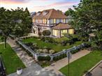 Welcome to this stunning, meticulously maintained corner home in the coveted Hollis Ct, boasting a massive 70x100 lot with a fully fenced, oversized backyard perfect for entertaining or creating your dream garden. This expansive property, exuding luxury found only in the finest mansions, features four spacious bedrooms, 3.5 opulent bathrooms, and a grand primary suite with a large custom bathroom. The first floor features a bright, airy living room with abundant natural light, a versatile flex space that can serve as a fifth bedroom or office, a convenient bathroom, and a state-of-the-art kitchen with endless cabinetry, a spacious pantry, top-of-the-line appliances, and direct backyard access. The second floor features three comfortable bedrooms and two exquisitely designed bathrooms. In contrast, the third floor offers a vast, versatile, and windowed space that can accommodate multiple beds or serve as a multi-purpose area. The basement features a large recreational room, a separate luxurious bar area with ample cabinetry, a custom surround sound system, a laundry room, a full bathroom, generous storage space, and a separate backyard entrance, adding unmatched functionality. Additional highlights include soaring high ceilings, gleaming hardwood floors, a complete security system, a large driveway, and a two-car garage. With low taxes and prime proximity to the LIRR (30 minutes to Manhattan), JFK Airport (15 minutes), LaGuardia Airport (25 minutes), major highways, big-brand stores, and restaurants, this move-in-ready masterpiece offers mansion-level luxury, space, and convenience in an unparalleled package.