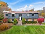 Spacious. Private. Minutes to Croton-Harmon Metro-North. Tucked away on a serene, shy 2 acres in Croton-on-Hudson, this 4-bed, 3-bath contemporary raised ranch blends comfort, privacy, and convenience. The main level offers a sunlit living room with a fireplace, an open dining area, and a beautiful eat-in kitchen with islandâ€”both with access to the deck. Ideal for entertaining or everyday living. Primary bedroom suite, two bedrooms, and full hall bath compete this level.The walk-out lower level offers incredible flexibility with a large family room, home office, den/bedroom/guest space with bathroom, laundry, and attached 2-car garage, perfect for remote work, multi-gen living, or creative use.Step outside to your own backyard retreat: pool with deck, multiple patios, and an additional detached 2-car garage with a fully outfitted woodworking studio - ideal for hobbyists, artists, or those in need of extra space. Plenty of parking.All just minutes from Croton-Harmon station and under an hour to Grand Central. With space, upgrades, and location, this one checks all the boxes. Private showings available.