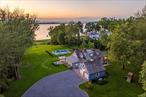 Tranquility Discover the epitome of waterfront living in this meticulously renovated Hampton-style home, where every sunrise and sunset becomes your personal masterpiece. Positioned on a coveted stretch of Oyster Bay Harbor with 185 feet of private waterfront, this exceptional 3.5-acre estate offers an unparalleled blend of luxury, comfort, and natural beauty. The complete renovation was masterfully designed by the renowned architectural firm of Smiros & Smiros, known for their timeless elegance and attention to detail.Approached by a long, estate-style drive, this cedar-roofed, cedar-shingle residence showcases refined interiors. Detailed with shiplap ceilings, rich hardwood floors, custom built-ins, new lighting, replacement windows, new bathrooms, renovated kitchen and two wood-burning fireplaces that anchor the home with timeless charm.The heart of the home is a sun-filled open floor plan that seamlessly blends the living room, dining area, and denâ€”perfect for entertaining or relaxing by the fire. A high-tech galley kitchen features lacquered and stainless steel cabinets, quartzite countertops, top tier appliances, and a walk-in pantry, with direct access to a shaded patio for seamless indoor-outdoor living.The tranquil primary suite on the first floor enjoys panoramic views of the bay, grounds, and in-ground heated pool, and includes a stunning window-wrapped sitting room that captures the light and natural beauty of the setting. Upstairs are two additional bedrooms and a stylish hall bath. The lower level includes a versatile fourth bedroom or multipurpose room with a new full bathâ€”ideal for guests, a gym, or remote work.A charming breezeway with slate flooring connects the home to the two-car garage, also finished with slate flooring. Ample room for additional parking.The lushly landscaped grounds highlight a saltwater pool and separate hot tub, both thoughtfully designed with a detailed stone retaining wall that echoes the craftsmanship of the existing rhododendron garden wall. Beyond the pool, your own private beach awaits, complete with available mooring rights and direct access to the Long Island Sound just around the bend. With private police and the ultimate in seclusion, this waterfront haven offers an extraordinary opportunity to live surrounded by beauty, peace, and prestigeâ€”just an hour from Manhattan.