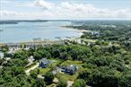 Newly constructed home on a generous acre, just a few hundred yards from the Peconic Bay. This spacious and thoughtfully designed residence features a sun-filled living room with a gas-burning fireplace overlooking the backyard, as well as a large eat-in kitchen with a charming dining nook. Just off the attached two-car garage is a mudroom, designed for beachhouse living, complete with a laundry room. The first-floor primary suite offers a resort-style full bath and a large walk-in closet, creating a peaceful retreat. Upstairs, youâ€™ll find two guest bedrooms connected by a shared ensuite bath, along with additional guest room and flex bonus room with dedicated full bath. Enjoy both a classic front porch and an expansive back deck overlooking your private yard, in-ground pool, and built-in outdoor kitchen. The full-height, unfinished walkout basement includes a finished full bath and offers a prime opportunity for future expansion. Located just minutes from downtown Greenport Village, with bay access at the end of the street. Don&rsquo;t miss the chance to view this custom-built home.