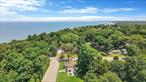 Location, location! Nestled in a highly desirable beachside community, this sun-drenched and fully updated 3-bedroom, 2-bath split ranch offers the perfect blend of coastal charm and modern luxuryâ€”with private access to the water just a stones throw away. Make this your year round or weekend getaway. Step inside to an open-concept main level featuring soaring ceilings, gleaming hardwood floors, and a spacious living and dining area. The beautifully renovated eat-in kitchen is a showstopper, with crisp white cabinetry, quartz countertops, a glass tile backsplash, stainless steel appliances, and a stunning center island with seatingâ€”ideal for entertaining. Custom blinds and recessed lighting add a refined touch throughout. Both bathrooms have been thoughtfully updated with modern ceramic tile and high-end finishes. The lower level offers a den with sliding doors to the outside and a full bathâ€”perfect for guests, a home office, or extended living space. An additional third bedroom or entertainment area awaits on the lowest level, providing flexible space for gatherings, game nights. All of this, located just minutes from award-winning wineries, top-rated restaurants, and outlet shopping. This beachside beauty wonâ€™t lastâ€”donâ€™t miss your chance to own a piece of paradise on Long Islandâ€™s North Shore!