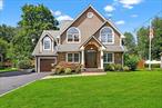 Absolutely stunning colonial in Nanuet, NY!This four-bedroom, three-and-a-half-bath colonial sits on 1/3 of an acre and offers over 4, 000 square feet of finished living space. A true architectural masterpiece, it features striking rooflines that create dramatic visual interest both inside and out.Set back from the road and introduced by an expansive driveway, stone walkway, and tastefully designed landscaping, the approach is as impressive as the home itself.The fully fenced backyard is complete with an expansive patio, storage shed, and generous green space, creating the perfect environment for entertaining or simply relaxing at home.Step inside to a show-stopping entry, where a staircase with oak treads, sleek metal spindles, black risers, and a coordinating black railing makes a bold statement. Gleaming white oak hardwood floors run throughout the first and second levels, complemented by a neutral color palette and recessed or overhead lighting in every room. Formal living and dining spaces flank the staircase, each flooded with natural light through oversized windows. These calm, elegant rooms provide the ideal setting for entertaining or everyday living.The kitchen is massive and beautifully designedâ€”featuring maple cabinetry, large-format porcelain tile floors, granite countertops, and Frigidaireâ€™s Professional Series stainless steel appliances, including a huge side-by-side refrigerator/freezer and ice machine. A large center island comfortably seats six, and a cozy breakfast nook at the rear of the kitchen offers tranquil views of the backyard.And this kitchen has a surprise. What looks like a pantry cabinet is actually a hidden door leading to an appliance kitchenâ€”perfect for your coffee-making, toasting, and blending needs. On trend and ultra- functional, it also connects directly to the garage, making it the ideal drop zone for groceries.Spacious family room anchored by a gas fireplace with quartz surround, a classic wood mantel, and a mounted flat screen above. From there, French doors lead to a spectacular three-season room, approximately 19&rsquo; x 16&rsquo;, with rich mahogany floors, planked walls and ceiling and a stunning stone accent wall. With direct access to the patio, itâ€™s sure to become one of the most loved spaces in the home.A stylish powder room completes the main level.Upstairs, the primary suite is simply exceptional. Dramatic rooflines and cathedral ceilings define the space, with reverse gable details adding character and warmth. A floor-to-ceiling fireplace with custom paneling adds a cozy focal point, while sliding glass doors open to a Juliet balcony. A spiral staircase leads to a private loftâ€”perfect for a home office, gym, creative studio, or peaceful retreat.The spa-like primary bath features a large double-sink vanity, soaking tub with air jets, and a double-wide, frameless glass shower. A massive walk-in closet completes the full en-suite experience.Three additional bedrooms are found on this level, each showcasing beautiful rooflines, large Palladian windows, and double closets. They share a well-appointed hall bath with a tub/shower combination.The lower level offers even more living space, including a second family room with a wood-burning stove, a guest room, and the home&rsquo;s third full bathroom. Youâ€™ll also find a large laundry/mudroom and a separate storage area that could easily function as a gym or home office.Located in the blue ribbon Nanuet school district, and just minutes from top-tier shopping, dining, and major highwaysâ€”with easy access to Bergen Countyâ€”this home offers the perfect combination of style, space, and convenience. This is one of those homes that just has it all.