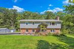 This lovely move-in ready raised ranch is set on 1.8 peaceful acres just minutes from Uptown Kingston. Thoughtfully upgraded inside and out, this home offers flexible living space and plenty of room to enjoy the outdoors. Many large improvements and updates were made within the last few years. You&rsquo;ll love the beautiful kitchen which is open to the dining area, and appreciate the newer windows, siding, roof, and utilities. Upstairs there are three bedrooms, a spacious living room enhanced with a gas fireplace, and a bathroom with double vanity. The lower level offers a private guest or in-law suite with it&rsquo;s own entrance and electrical serviceâ€”perfect for extended family or flexible living needs-or great income potential, all ready to go! A generator adds peace of mind. The exterior is just as impressive with lush landscaping, a fully fenced organic vegetable garden with excellent sun exposure, a large private back patio for entertaining, and a peaceful walking trail through the property. A huge shed offers tons of space for storage or hobbies. Additional gravel parking pad and second driveway provide ample room for guestsâ€”and are ideal for an RV or camper setup. Unbeatable location, bordering the quiet hamlet of Hurley, 3 minutes to the historic Stockade district and the NYS thruway, and 15 minutes up Rt 28 to Woodstock.