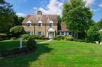 This timeless and classic Colonial comprises 11 rooms across 3, 258 square feet with 4 bedrooms, 3 full and 3 half bathsâ€”in the heart of Munsey Park. Built in 1938, it marries period detail with todayâ€™s open plan living. The kitchen, with peninsula island, custom cabinetry and stone and Corian counters, flows into a bright breakfast area and an expansive family room with high ceilings, a focal point large window and stone-clad gas fireplace. The wood paneled library with stylish powder room and the lovely sunroom offer work-from-home and entertaining spaces. The main level also features a bedroom with a new ensuite bath and a mudroom with side yard entry. Upstairs, the primary suite boasts built ins and a show stopping bath with radiant floors, a custom vanity and spa shower. Two additional bedrooms share a remodeled hall bath with double sinks and a jetted tub. The lower level provides a rec room with fireplace, generous laundry, wine closet, half bath and abundant storage. Outside, a Trex deck leads to a bluestone patio and private yard, while an attached, refreshed two car garageâ€”with storage, EV charger and epoxy chip floorâ€”completes the picture. Steps from Munsey Park Elementary, itâ€™s the home you may have admired on the school run. This forever home awaits its next chapter.
