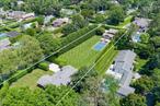 At .61 of an acre, 64 Armand is nearly 3 times larger than many other homes on the market in Southampton Village. A truly unmatched triple-lot that stands alone in its beauty, privacy, and potential. Framed by mature 20â€™&#160;cypress hedge on the&#160;south side&#160;and a towering 60â€™&#160;arborvitae hedge on the north, this expansive and impeccably manicured property is a private East End sanctuary. At its center sits a charmingly updated three-bedroom, three-bathroom home, where timeless elegance meets modern comfort. Sun-drenched interiors, custom finishes, and a seamless flow to the outdoors create a perfect setting for relaxed coastal living and effortless entertaining. The open-concept living and dining spaces are anchored by a custom fireplace and connect directly to the lush backyard through huge oversized sliding doors. A gourmet kitchen is outfitted with top-tier stainless steel appliances, bespoke cabinetry, and refined fixtures. The gracious primary suite with ensuite bath, two guest bedrooms, and an additional full bath round out the main level, with untapped potential in the lower level awaiting your vision. Step outside and discover the true heart of the estate: an expansive triple-lot features a 20&rsquo; x 40â€™&#160;saltwater gunite pool surrounded by bluestone patios, an arbor for shaded lounging, and the most spectacular, elegantly appointed pool house. The newly added structure is designed with soaring cathedral ceilings, a&#160;kitchenette, full high-end bathroom, and outdoor shower, the pool house is the ultimate complement to summer days and nights. A newly added detached two-car garage with its own private driveway offers ample space for vehicles, bikes, and beach gear, enhancing the functionality of the estate. Unique to this offering are ARB-approved architectural plans for a magnificent 5, 594-square-foot residence with six bedrooms and six-and-a-half baths, saving you months and months of time and considerable architectural costs. Whether you&rsquo;re looking to expand upon the current home or envision building your own bespoke retreat, the possibilities are truly endless at 64 Armande. Just moments from world-renowned beaches, fine dining, boutique shopping, and the best of village life, this property represents a rare chance to own a generational compound in one of the Hamptons&rsquo; most prestigious enclaves.