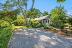 Discover a unique corner property in Brightwaters surrounded by lovingly tended gardens. This sun-filled home features a spacious living room with pine floors, stained-glass accent window, and wood-burning stove. The sky-lit eat-in kitchen boasts high ceilings, stainless appliances, and a stained-glass window overlooking the west garden. The primary suite offers west garden view, oak flooring, an extra-large, customized walk-in closet, and a spa-inspired bathroom. Additional bedrooms include thoughtful built-ins and creative storage options. Natural light flows through large east and south facing windows in both the den and foyer. Enjoy bonus amenities like a partial basement, roomy attic, detached two-car garage with built-in shelving and more. Recent upgrades include a 4-year-old Pinnacle Premier high-performance roof, newer hot water heater, newer enhanced windows by Republic, and a two-zone gas boiler system. Located one block from beautiful Wohseepee Park. Come see for yourself!