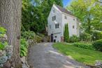 This wonderful 1929 Tudor is situated on a quiet tree-lined street. Just an easy walk to schools, parks, playgrounds, Metro North train station and Larchmont Village shops! Ultimate charm exudes from this three-level home that features original timber frame details and hardwood floors throughout. The main level offers a living room with fireplace that overlooks the front of the home, a refreshed kitchen with new white marble countertops, an updated powder room, dining room with French slider door to rear patio and backyard. The top floor offers three generously proportioned bedrooms with vaulted ceilings, a loft for storage and hall bath. The lower level offers a guest bedroom or office, storage and laundry.