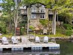 On the Shores of Lake Waccabuc. Absolutely amazing setting overlooking the water! Incredible Lakehouse offering true waterfront living with panoramic views. Originally built in 1939 and beautifully updated in 2015. Fabulous Living Room with vaulted ceiling, floor-to-ceiling stone fireplace and knotty pine paneling. Stunning open-layout Kitchen with dining and seating areas,  window walls and fabulous water views. Private Primary Suite with Dressing Room and luxurious Bath. Three additional Bedrooms. Private Office for working remotely. Multiple porches and decks allow for an easy indoor-outdoor lifestyle. Private funicular down to the lake with waterfront terrace, outdoor fireplace and large private dock. Incredible lake lifestyle with swimming, boating, paddleboarding and kayaking. First time offered in 30 years!