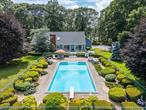 Welcome to 250 Peconic Bay Boulevard, a west-facing haven nestled on over an acre of beautifully landscaped grounds, offering breathtaking views of Reeves Creek with awe-inspiring sunsets. This home is a perfect blend of comfort and style, with its welcoming front foyer leading you into the heart of the house. The eat-in kitchen boasts stunning creek views that make every meal special. Adjacent to the kitchen is a spacious laundry room/mud room complete with a powder room and convenient access to the garage. The expansive living room features cathedral ceilings, skylights, sliding doors that open to the rear deck and yard, and a cozy wood-burning fireplace. French doors lead to the main floor suite, a serene retreat with sliding doors to the beautiful backyard and pool, a large walk-in closet, and a private bthrm. On the other side of the home, you&rsquo;ll find two additional bdrms and a full bthrm, offering ample space for relaxation. Above, a loft area with additional skylights provides an abundance of natural light and a lovely overlook to the living room below. The full basement with tall ceilings is a blank canvas for potential use or storage. The property also includes a 2-car garage for your convenience. Outdoors, a 20 x 40 fenced in-ground swimming pool awaits! Just around the bend from waterfront dining, and so close to beaches, wineries, farm stands. Experience living where every day feels like a vacation!