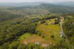 Welcome to East Mountain Overlook! This Two-Parcel Mountain Retreat is in the Heart of the Catskill Park where natureâ€™s grandeur meets opportunity. This unique offering includes two parcels â€”perfect for both peaceful living and visionary building. Parcel One â€“ 1.04 Acres with Trailer & Views - Perched high above the surrounding landscape, this cozy trailer offers sweeping panoramic views that change with the seasonsâ€” enjoy the beauty of morning sunrises and sunsets! It&rsquo;s move-in ready, allowing you to live comfortably while you build your dream home on the nearby acreage. Parcel Two â€“ 5.27 Acres with Garage & Well. Just down the road lies a second parcel with equally as amazing views, this property includes a solid garage structure and a drilled well in placeâ€”ideal infrastructure for your future build. This property abuts hundreds of preserved acres in the Catskill Forest Preserve, ensuring lasting privacy, boundless recreation, and an unspoiled backyard of hiking trails and wildlife. Multiple Possibilities, use the trailer as a full-time residence or temporary dwelling while building. Expand or replace the trailer for guest housing or rental income. Design a new home that captures stunning mountain views and blends seamlessly with the natural surroundings. Located on a quiet mountain road, yet within reach of charming Catskills towns, skiing, fishing, and farmerâ€™s marketsâ€”this is a rare chance to own not one but 2 pieces of paradise with serious potential. Whether you&rsquo;re seeking serenity, space, or investment, East Mountain delivers!
