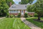 Presenting this Lovely Cape Cod House with brick and vinyl siding and detached garage with carport. This home boasts 4 bedrooms, with the primary on the first floor. There are 2 full bathrooms, one on each floor. The living room includes an inviting and cozy fireplace enhanced with a brick wall.  Basement is full with outside entrance. Situated on a private dead end block in the heart of Albertson, close to park, shopping and transportation.