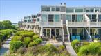 Resort-style oceanfront living awaits at the highly desirable Seascape Condominiums in Westhampton. This southwest corner 2-bedroom, 2-bath unit offers rare, uninterrupted views of the Atlantic and adjacent open dunes, thanks to its prime position next to vacant land. The open, airy interior features a bright living and dining area, a large kitchen island with seating for six, and a private deck perfect for lounging or dining al fresco. Both bathrooms are tastefully updated with marble countertops, tile, and flooring and polished chrome fixtures. Additional comforts include three ductless air conditioning/heating units and a standard-sized in-unit washer and dryer. A private boardwalk leads to the heated saltwater gunite pool, outdoor showers, foot baths, and the pristine ocean beach. The complex underwent a full exterior renovation in 2021â€“2022, including new siding, decks, sliders, and windows. With a pet-friendly policy, 24/7 live-in resident manager, plenty of storage, and beautifully maintained grounds, Seascape offers turn-key luxury in one of the Hamptonsâ€™ most coveted beachfront communities.
